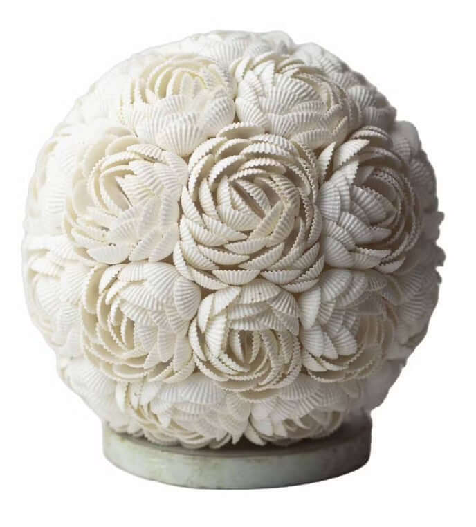 Decorative sphere made of white seashells on a white background lapm