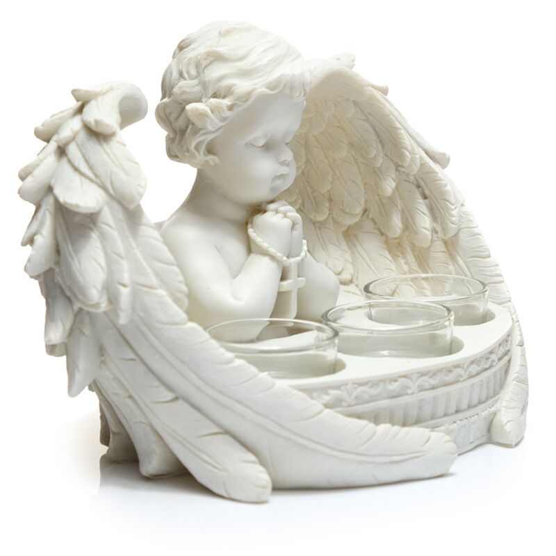 White angel figurine with candle holders on a white background