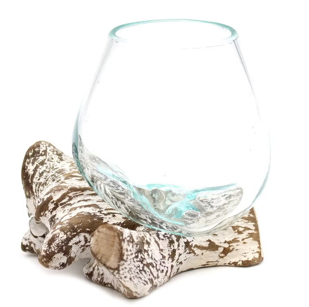 Glass bowl on a decorative wooden stand with a white background