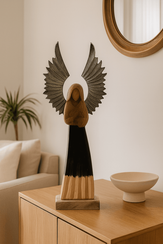 Decorative angel sculpture on a wooden table with a neutral background