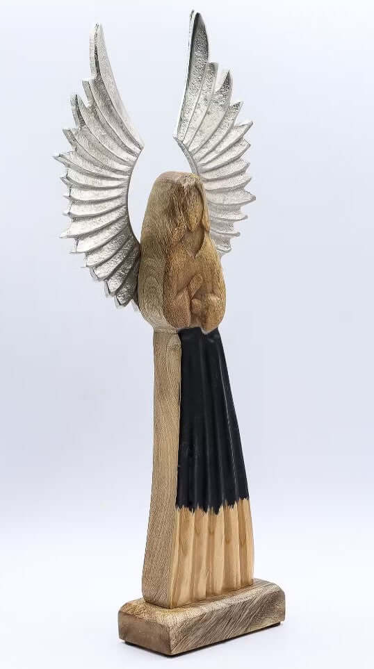 Wooden angel figurine with black scarf and silver wings on a white background