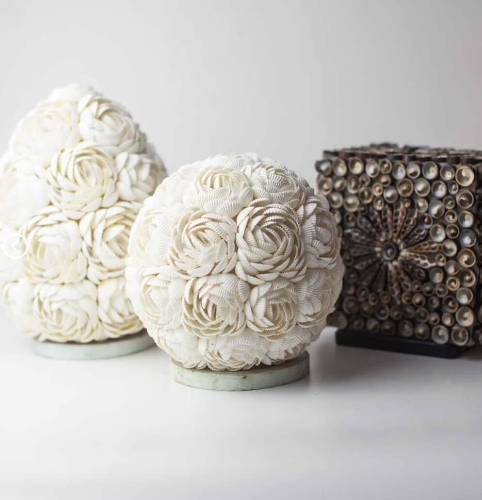 Decorative spherical objects with floral patterns on a white background