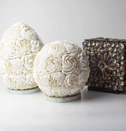 Decorative spherical objects with floral patterns on a white background