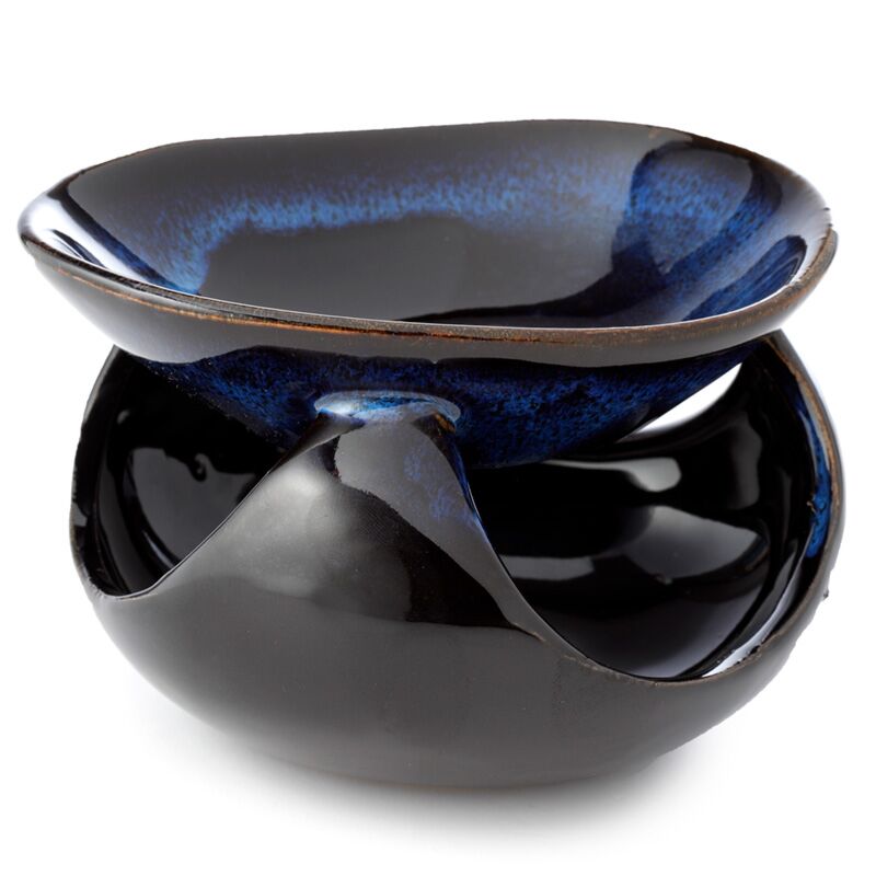 Two ceramic bowls, one blue and one black, on a white background
