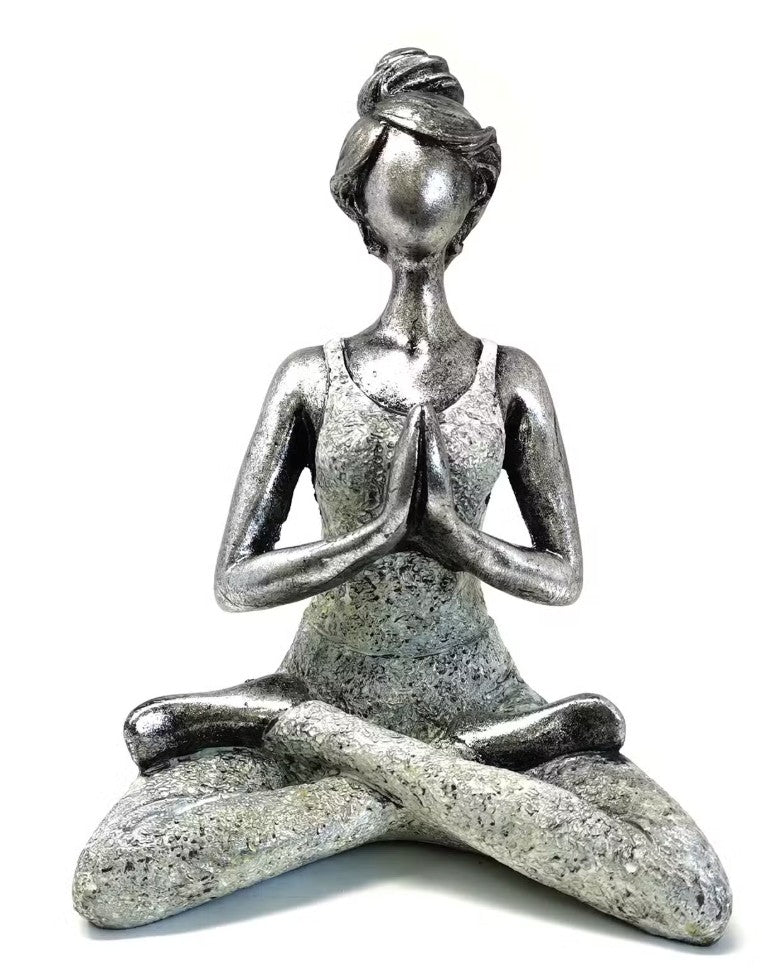Silver yoga pose figurine on a white background
